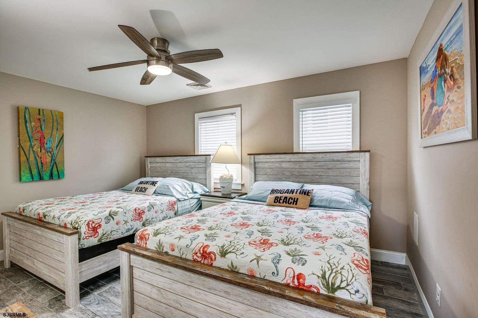 210 34th Street South, Unit 2 Brigantine, NJ 08203 - Photo 9 of 32 a bedroom with two beds and painting on the wall