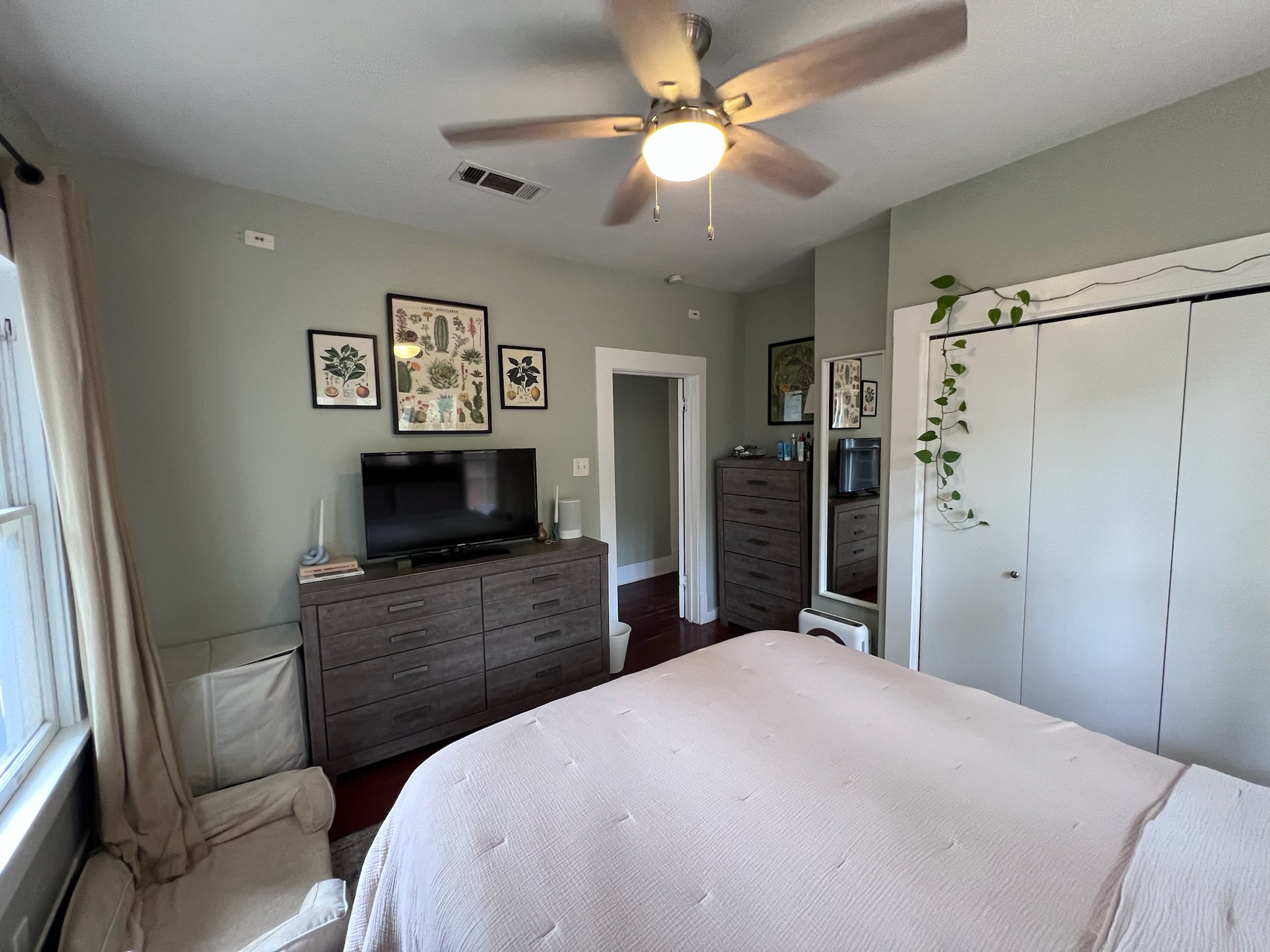 307 East 35th Street, Unit A Austin, TX 78705 - Photo 17 of 31 Well-lit sleeping quarters feature rich hardwood flooring and a functional ceiling fan for optimal comfort.