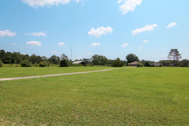 a view of a green field with clear sky