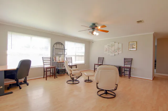 a view of a livingroom with workspace and a window