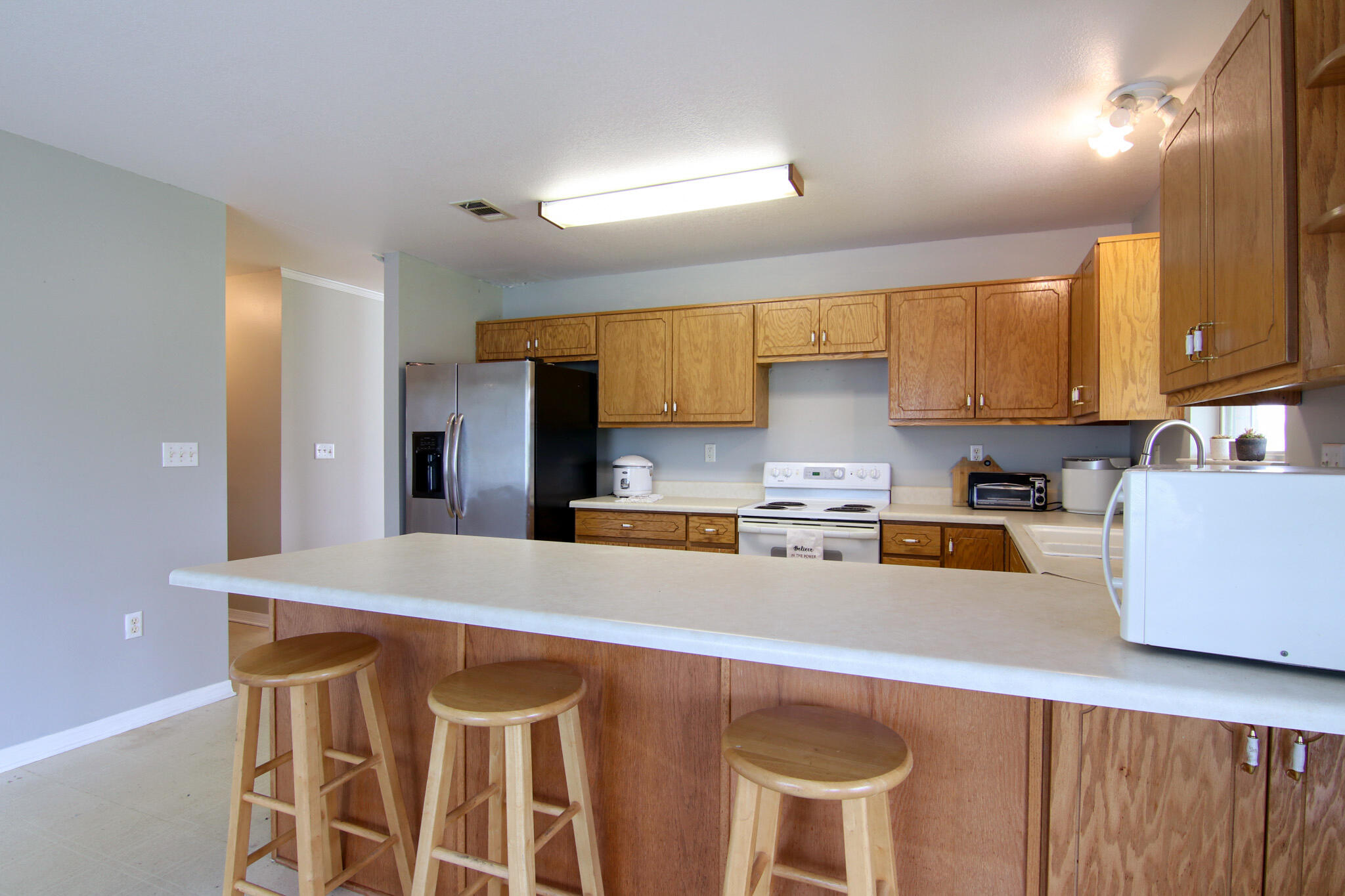924 Hwy C4a Baker Baker, FL 32531 - Photo 27 of 47 a kitchen with stainless steel appliances granite countertop a table chairs sink and cabinets