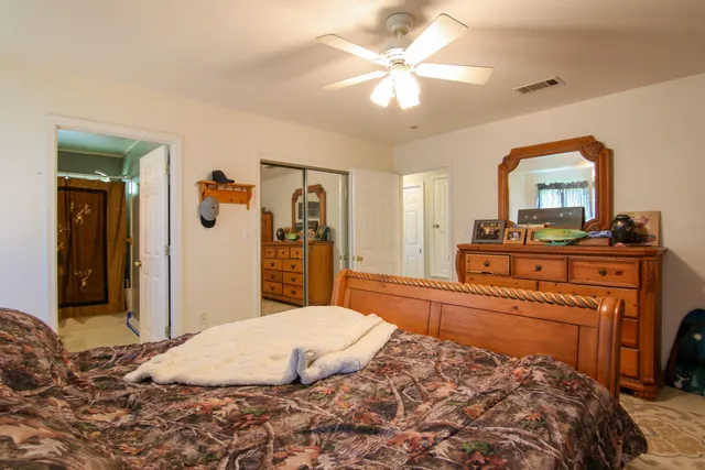 a bedroom with a bed and a dresser in it