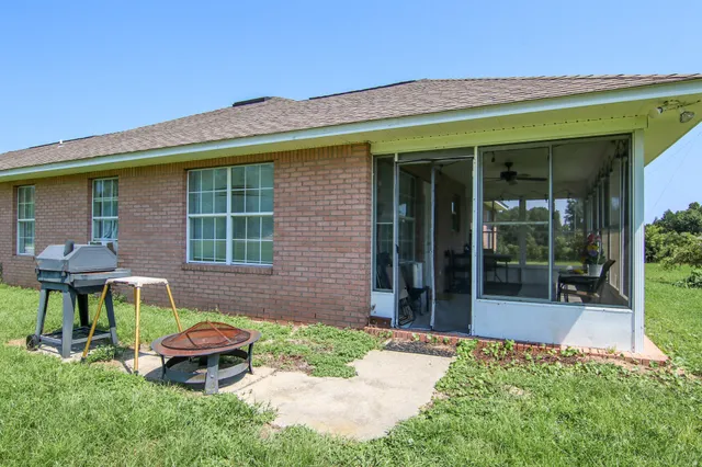 a living room with furniture windows and a flat screen tv