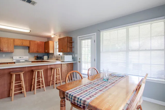 a large kitchen with a table and chairs in it