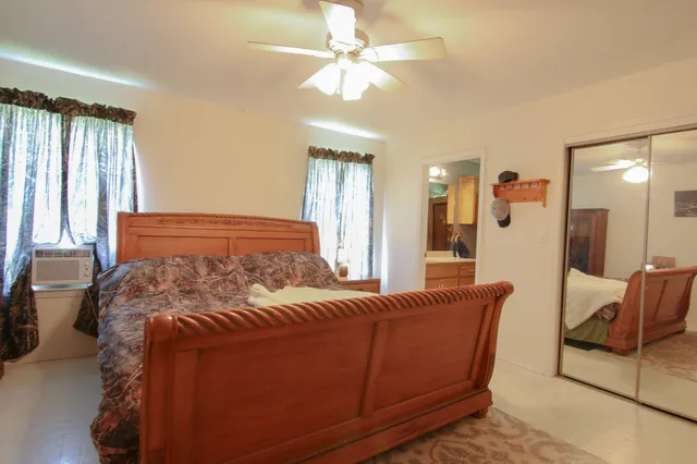 a bedroom with a bed couch and window