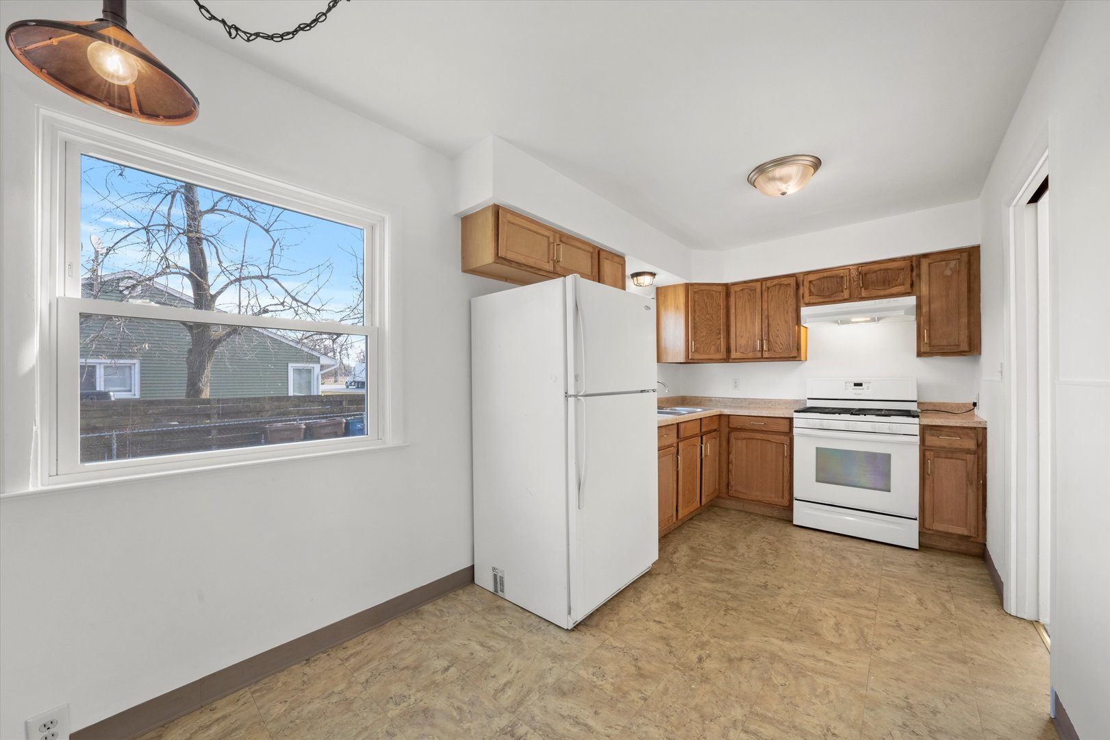 5628 West Monee Manhattan Road Monee, IL 60449 - Photo 14 of 37 a kitchen with a refrigerator and a stove top oven