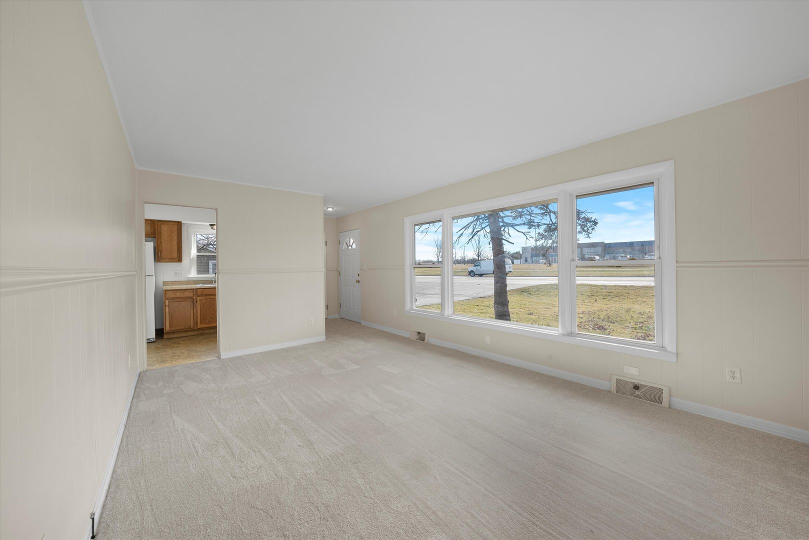 5628 West Monee Manhattan Road Monee, IL 60449 - Photo 6 of 37 an empty room with a fireplace and large window