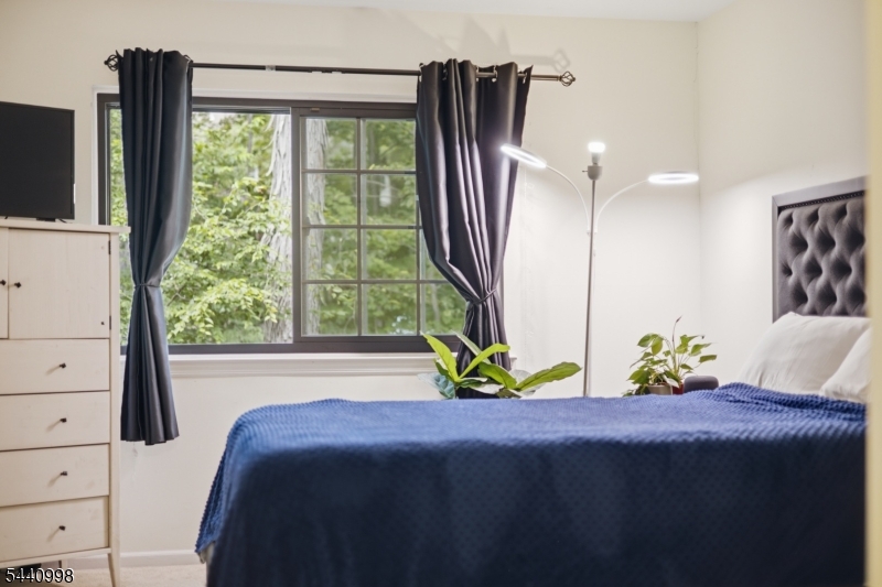 609 Mark Twain Way Mahwah, NJ 07430 - Photo 14 of 40 a bed sitting in a bedroom next to a window