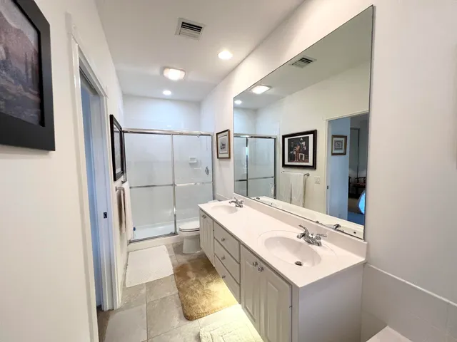 a bathroom with a sink mirror and shower