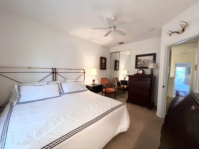a bedroom with a bed and ceiling fan