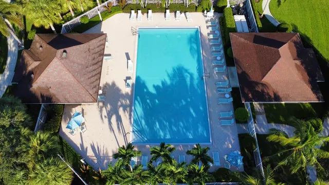an aerial view of house with yard swimming pool and outdoor seating