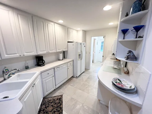 a kitchen with a sink stove and cabinets