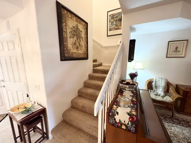 a living room with furniture and a painting on the wall