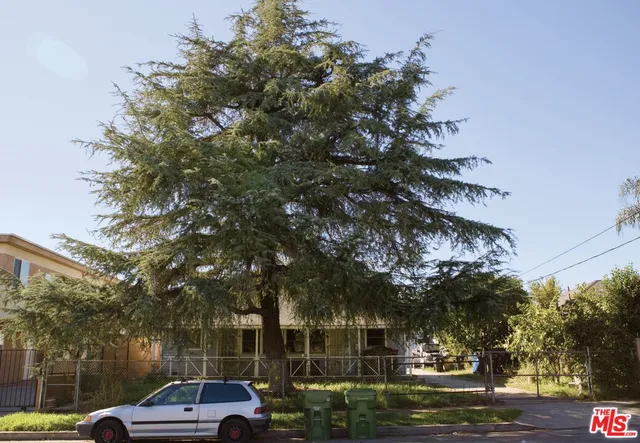 a view of cars parked on a sidewalk next to a building