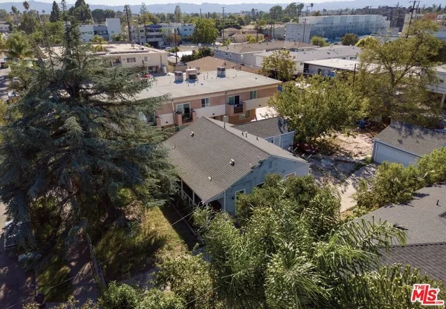 an aerial view of a house with a yard basket ball court and outdoor seating
