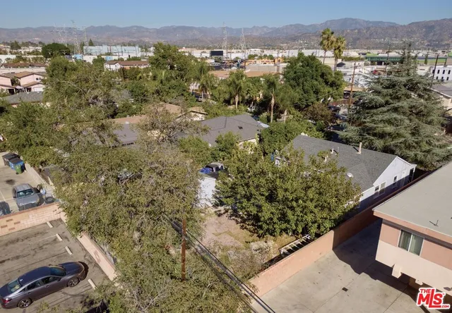 an aerial view of a house with a yard