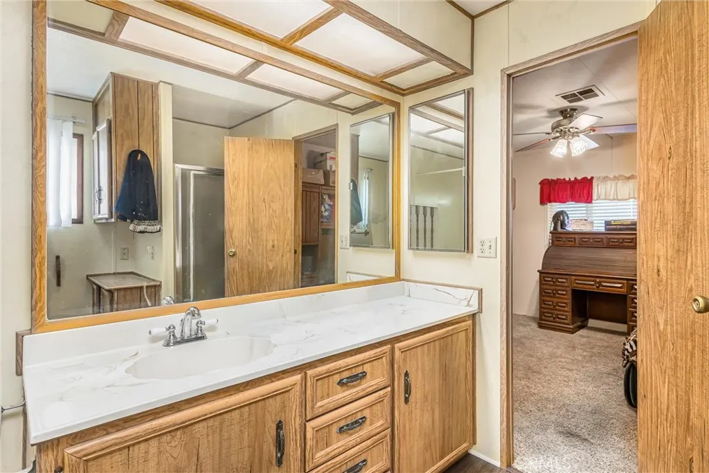 4000 Pierce Street, Unit 106 Riverside, CA 92505 - Photo 9 of 18 a bathroom with a sink and a mirror
