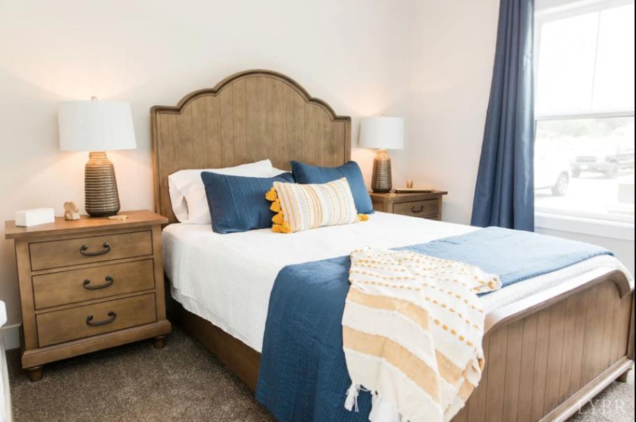 1300 Stoney Ridge Boulevard, Unit 101 Forest, VA 24551 - Photo 6 of 18 a bedroom with a bed and a dresser