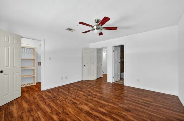 a view of empty room with wooden floor