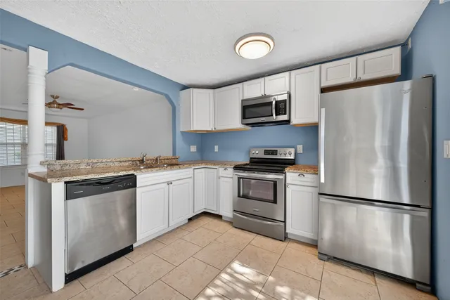 a kitchen with a refrigerator stove and microwave