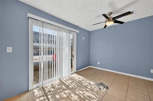 a view of a livingroom with a ceiling fan and window
