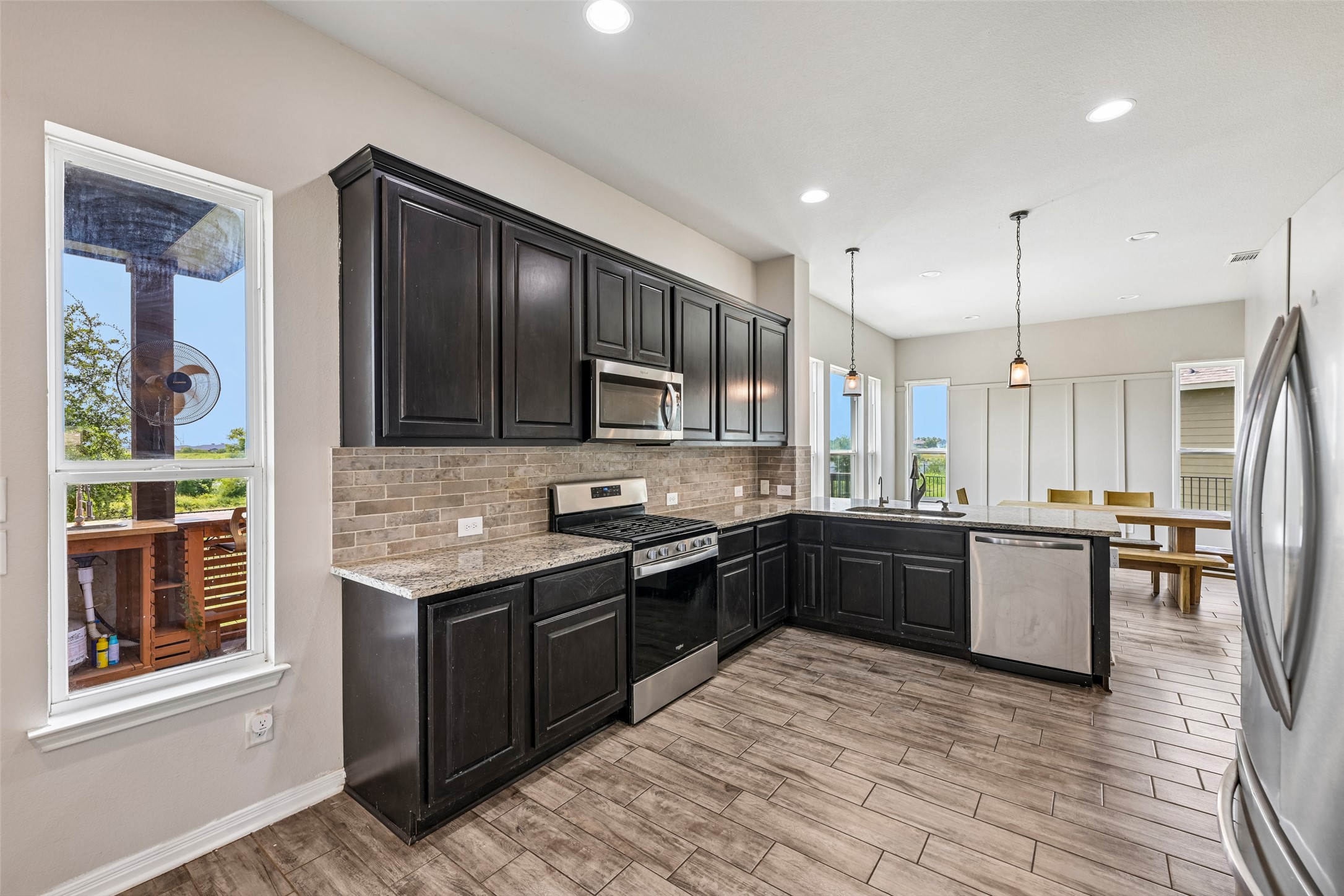 1297 Harwell Loop Kyle, TX 78640 - Photo 14 of 39 Culinary creations come to life in this contemporary kitchen, featuring abundant cabinetry and sleek appliances.