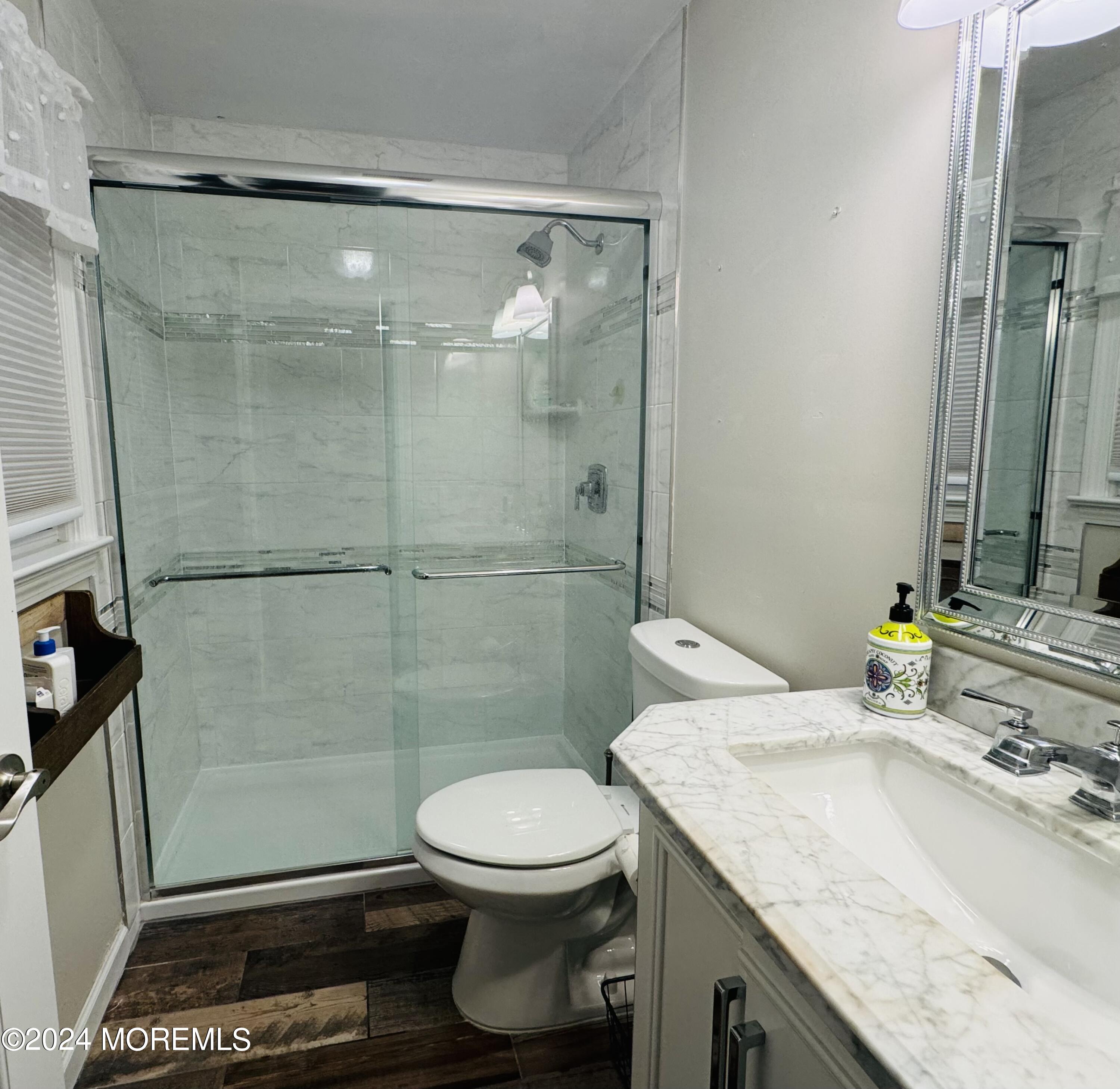 8 Old Farm Road Tinton Falls, NJ 07724 - Photo 17 of 24 a bathroom with a granite countertop sink a toilet a mirror and shower