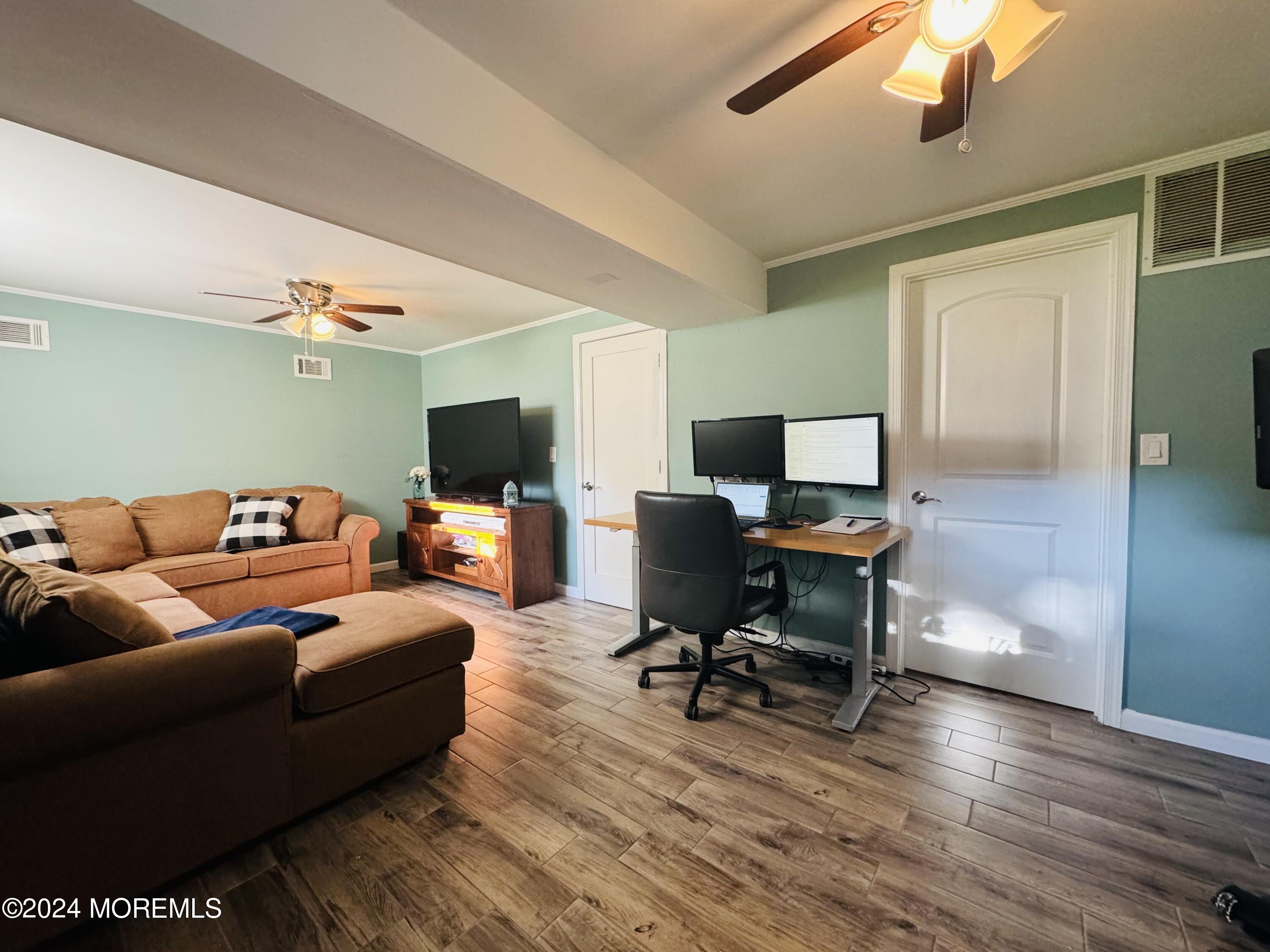 8 Old Farm Road Tinton Falls, NJ 07724 - Photo 19 of 24 a living room with furniture and a flat screen tv