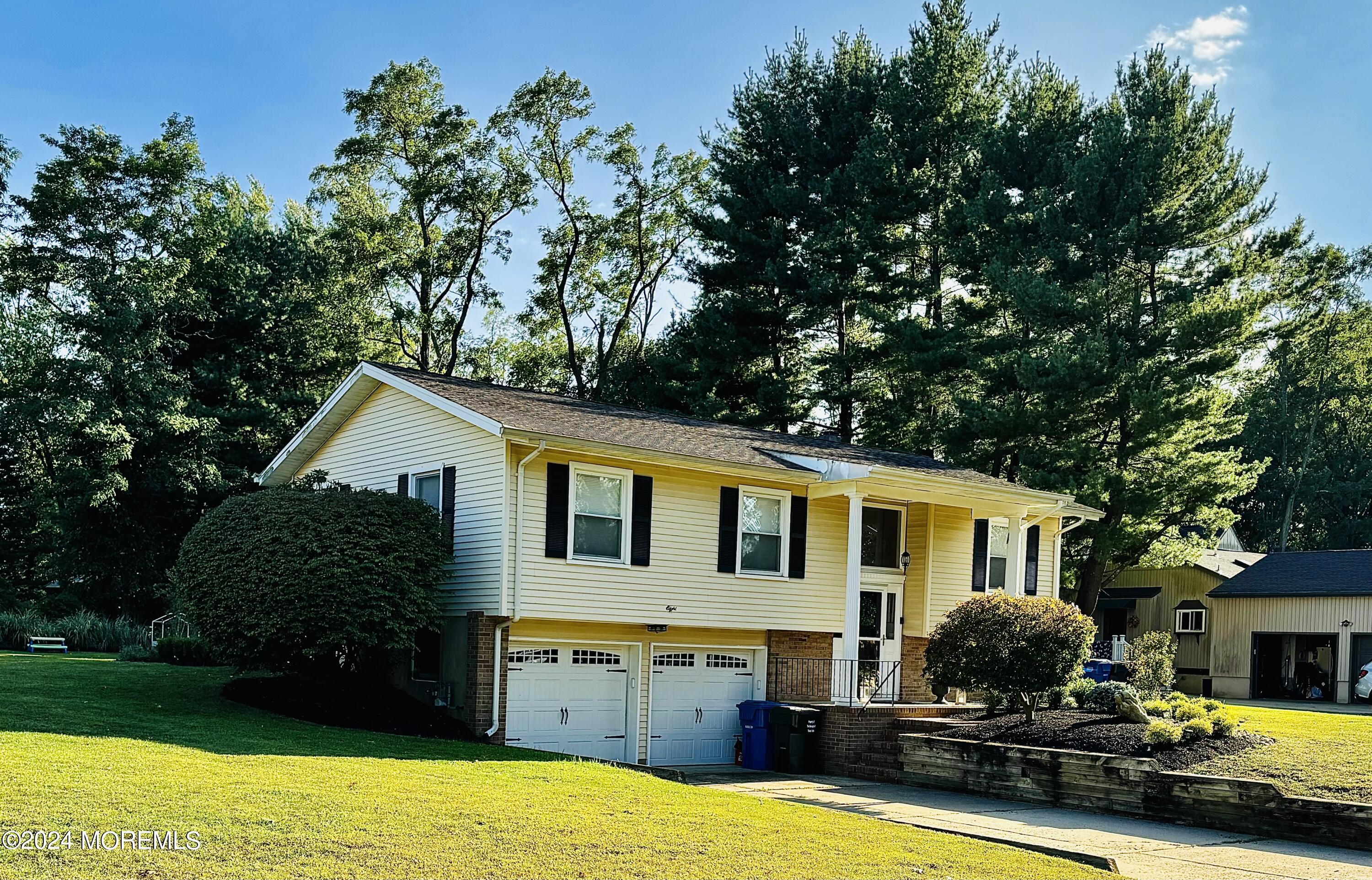 8 Old Farm Road Tinton Falls, NJ 07724 - Photo 3 of 24 a front view of a house with garden
