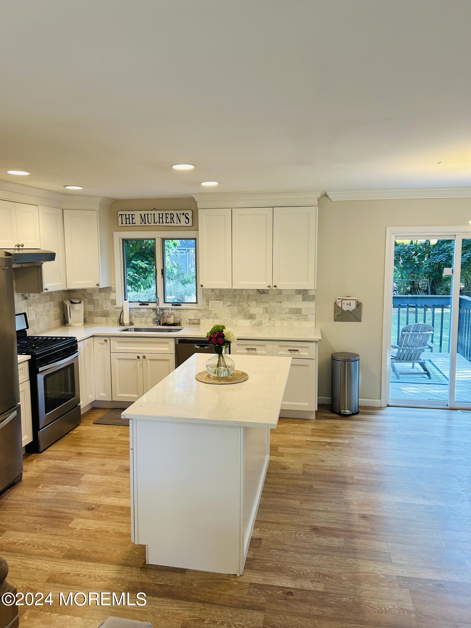 8 Old Farm Road Tinton Falls, NJ 07724 - Photo 5 of 24 a large kitchen with a center island and stainless steel appliances