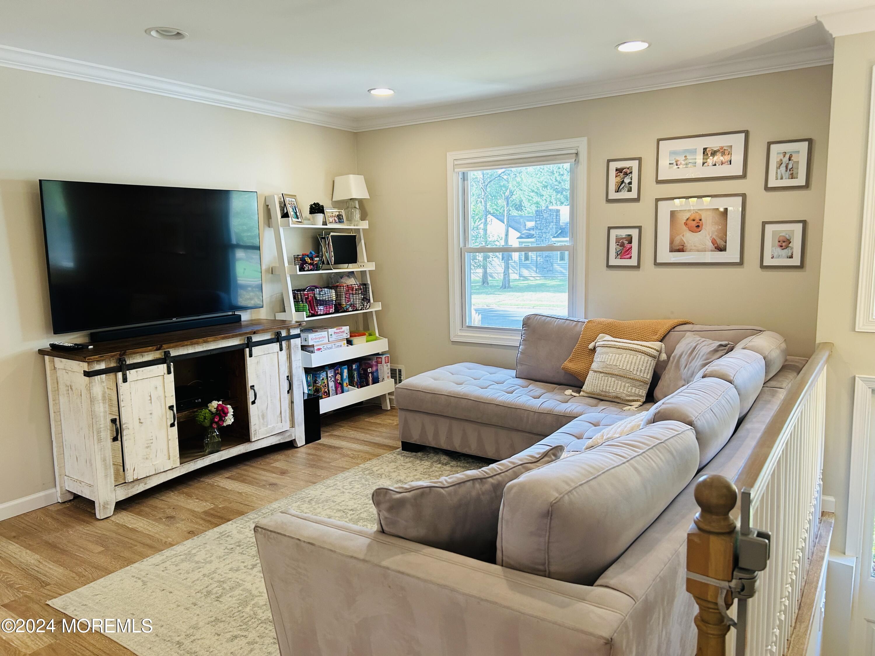 8 Old Farm Road Tinton Falls, NJ 07724 - Photo 10 of 24 a living room with furniture a flat screen tv and a window