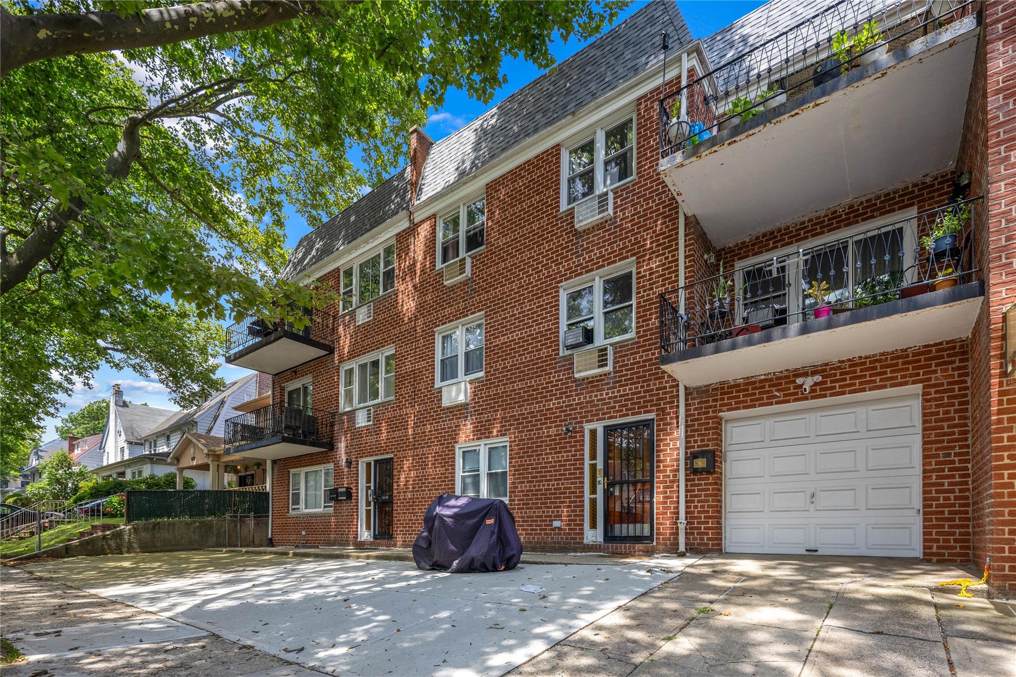a front view of a building with a yard