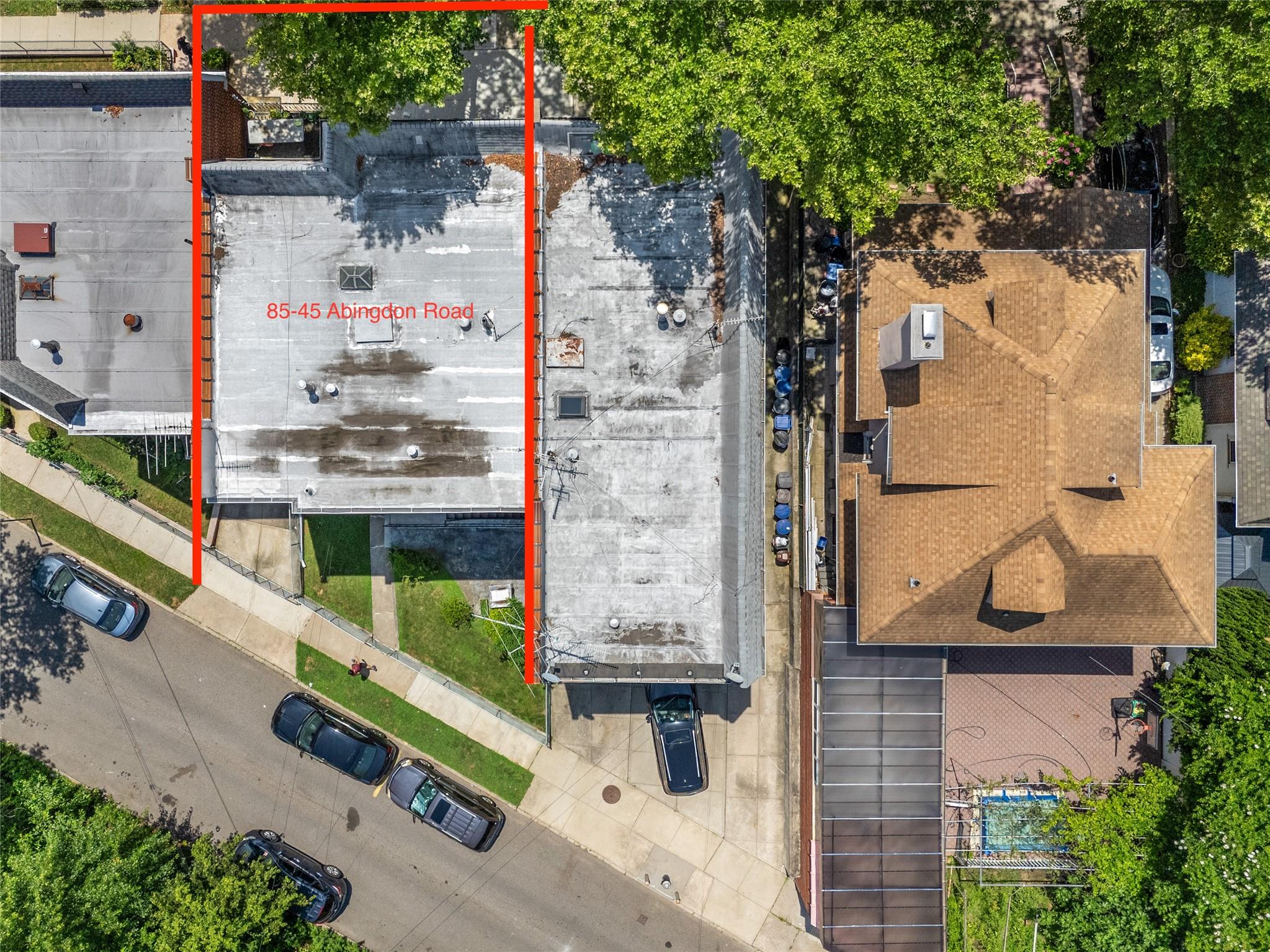 85-45 Abingdon Road Queens, NY 11415 - Photo 13 of 13 an outdoor space view with couple of cars parked in front of it