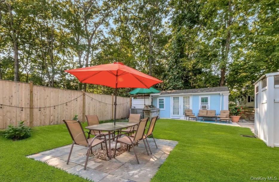 430 Grove Road Southold, NY 11971 - Photo 15 of 15 a view of a house with backyard sitting area and garden