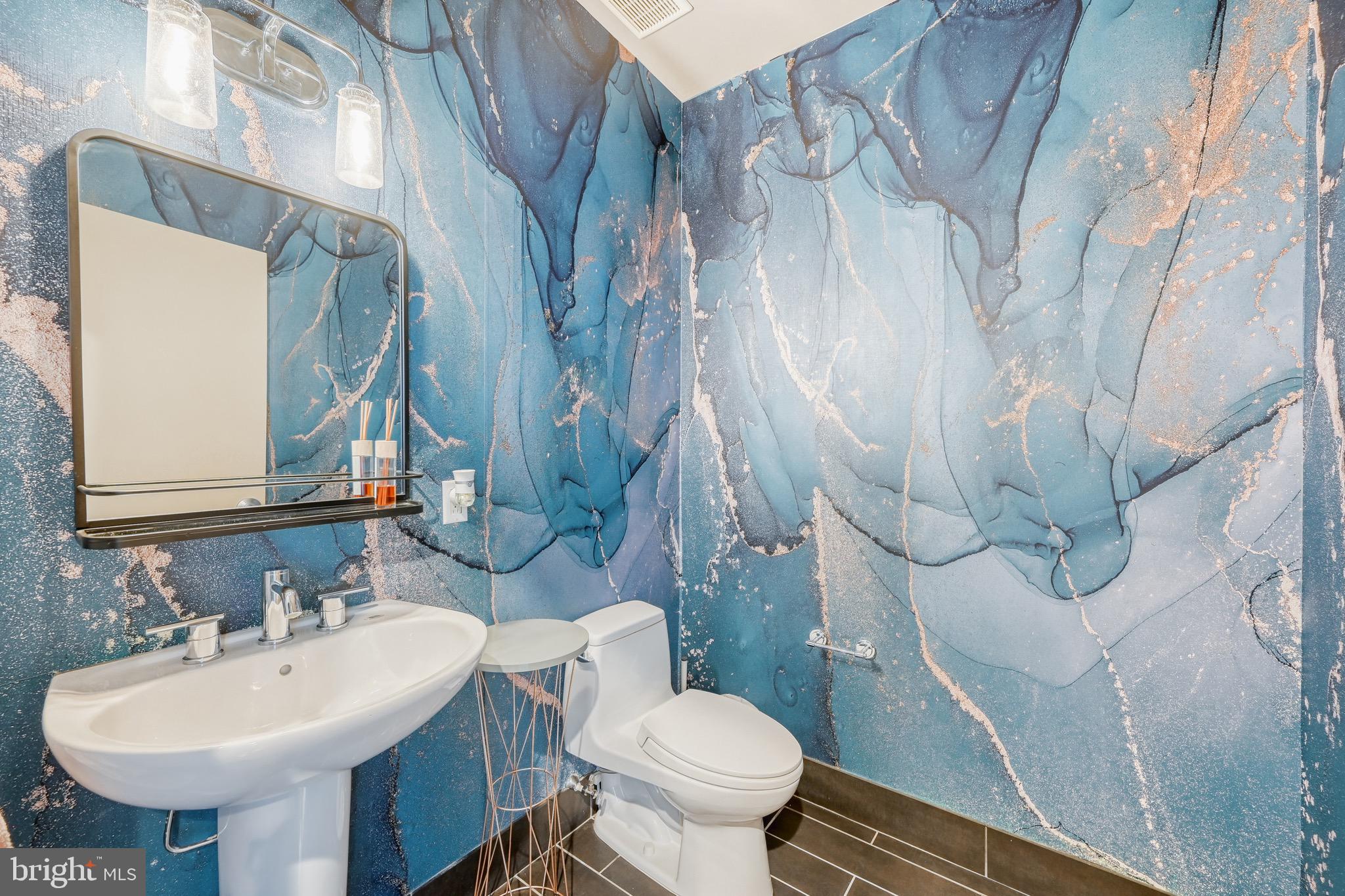 1200 Steuart Street, Unit 713 Baltimore, MD 21230 - Photo 15 of 43 a bathroom with a sink toilet and mirror