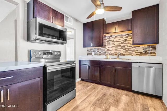 a kitchen with wooden cabinets and a sink