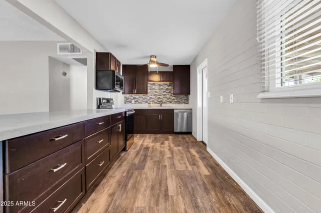 a spacious bathroom with a granite countertop sink and a mirror