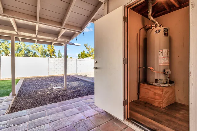 a view of an empty room with wooden floor and a ceiling fan