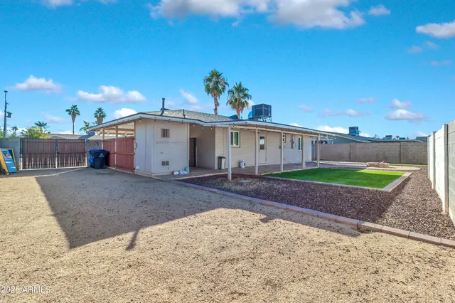 a view of a backyard with a barbeque grill and plants