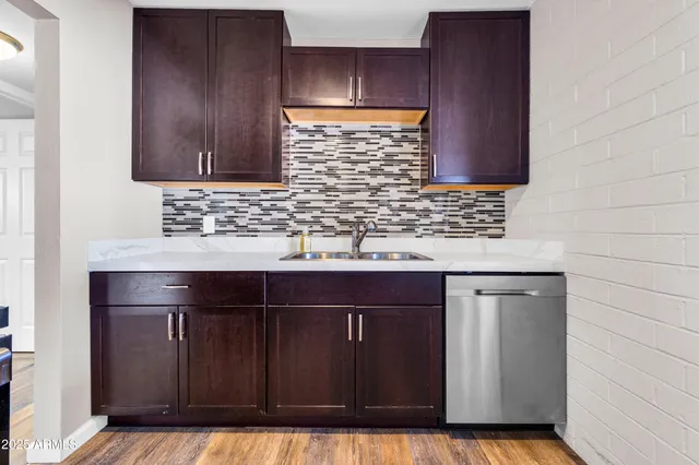 a kitchen with stainless steel appliances a stove a microwave and sink