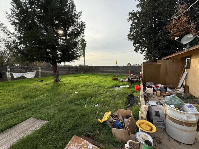 a backyard of a house with lots of green space and fountain