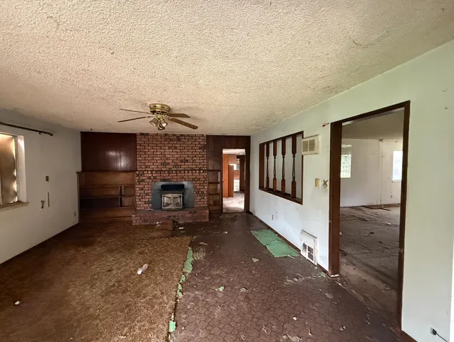a view of a livingroom with a fireplace and window