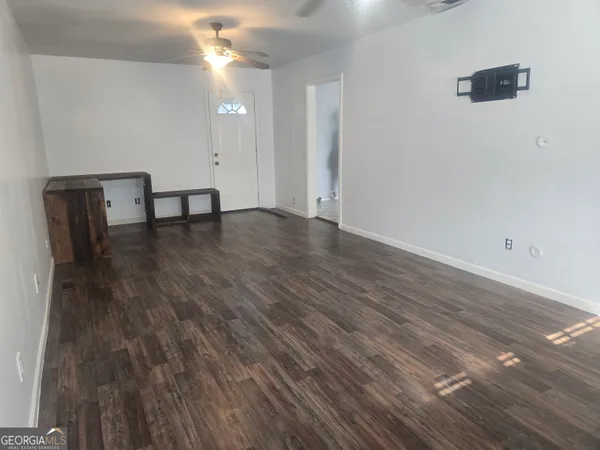 a view of a room with wooden floor
