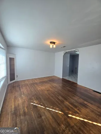 a view of an empty room and wooden floor