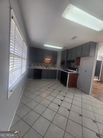 a kitchen with stainless steel appliances a stove a sink and a refrigerator