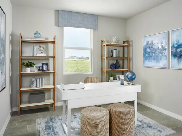 a room with a table chairs and a window