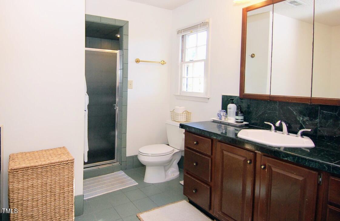 3414 Bellevue Road Raleigh, NC 27609 - Photo 11 of 20 a bathroom with a sink toilet and vanity