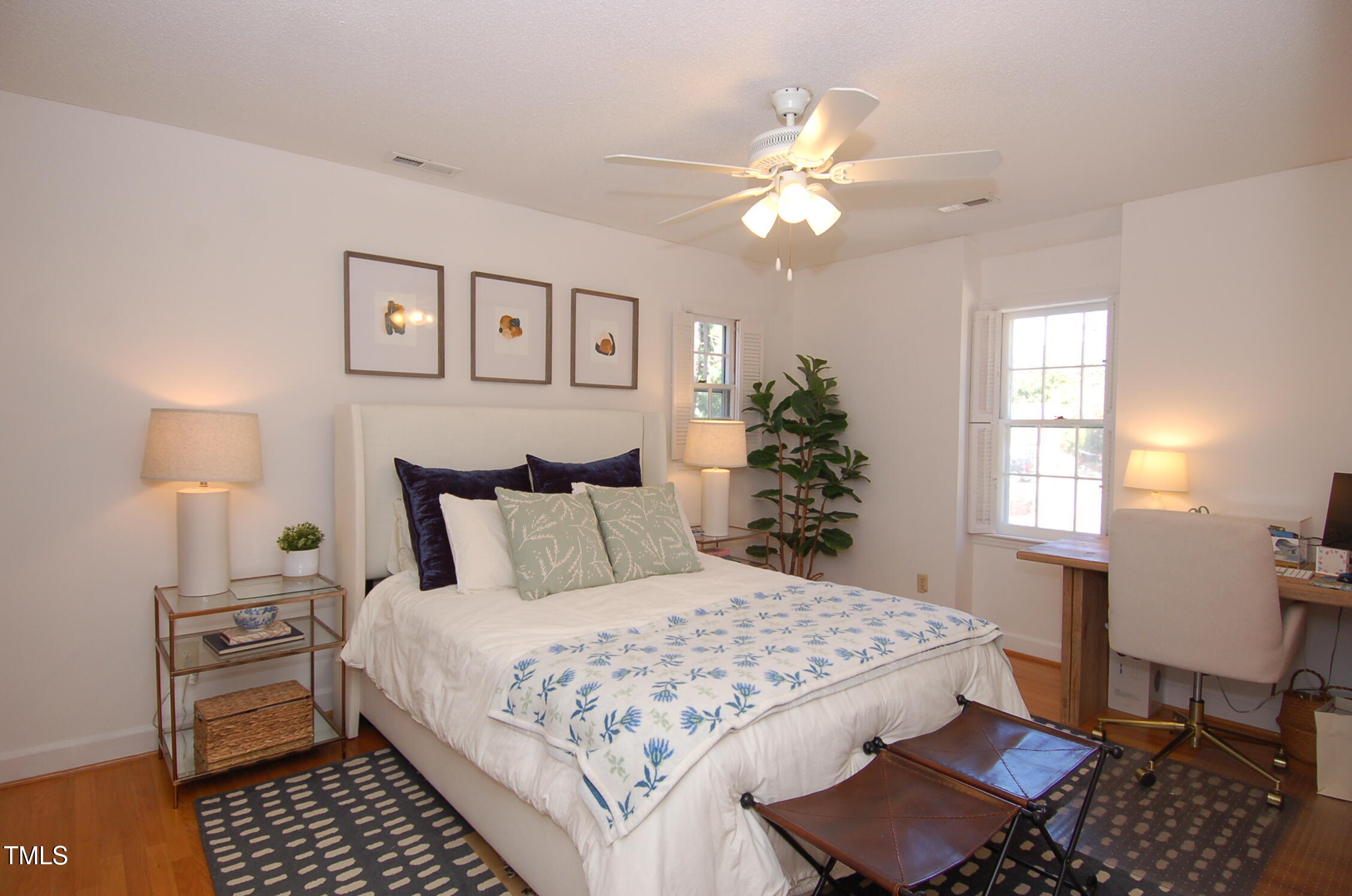 3414 Bellevue Road Raleigh, NC 27609 - Photo 12 of 20 a bedroom with a bed and a chandelier