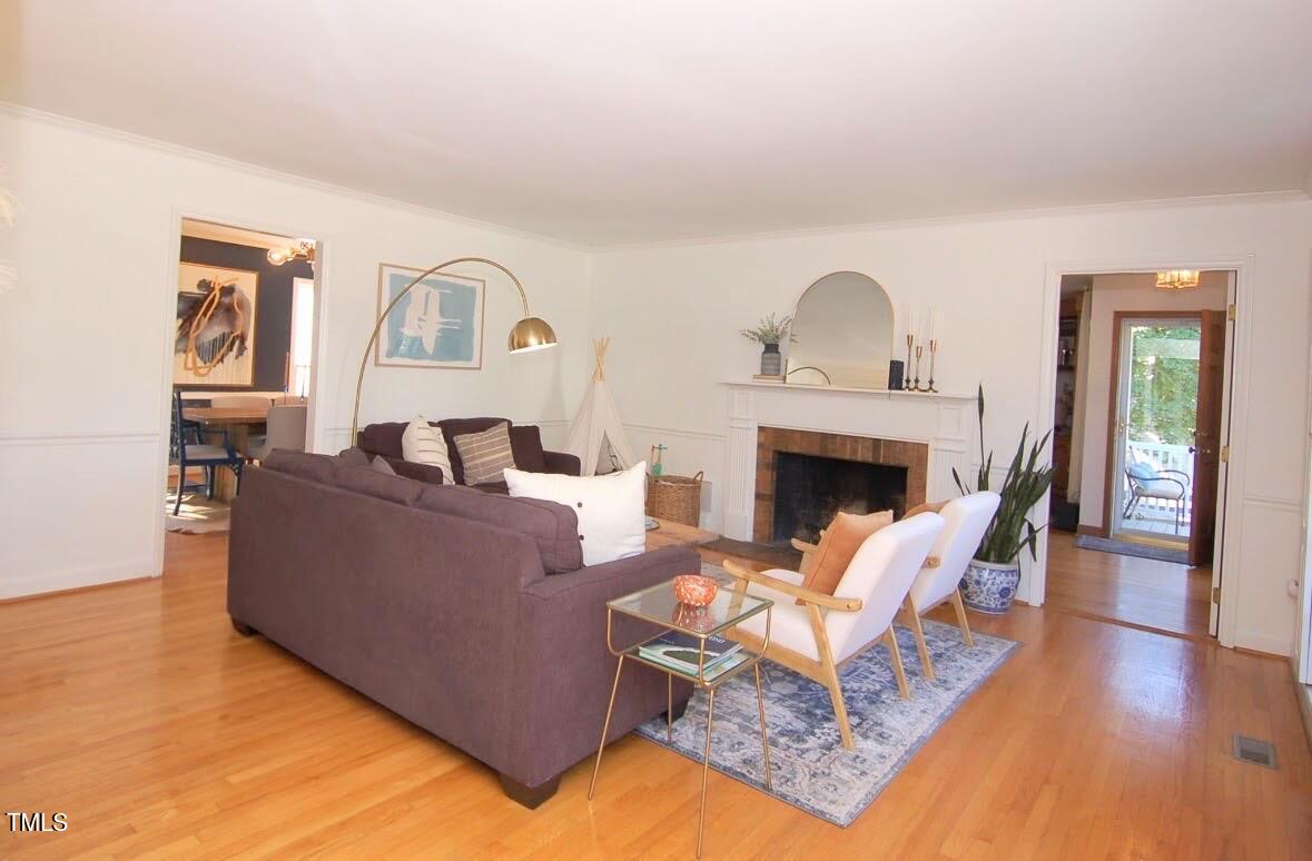 3414 Bellevue Road Raleigh, NC 27609 - Photo 2 of 20 a living room with furniture and a fireplace