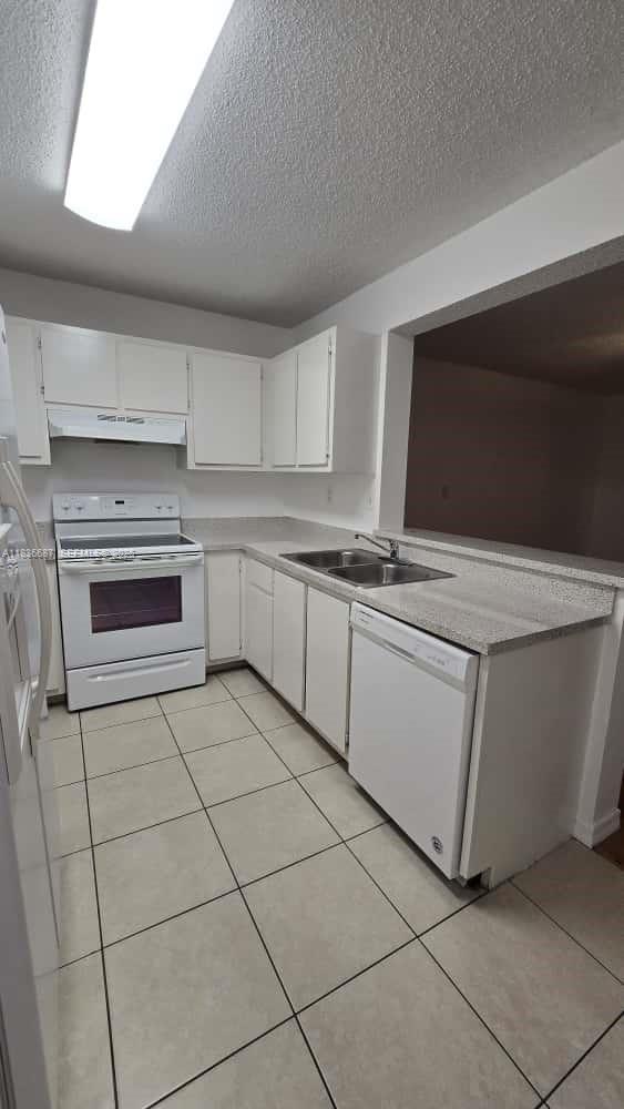 301 Palm Way, Unit 205 Pembroke Pines, FL 33025 - Photo 11 of 23 a kitchen with cabinets and appliances